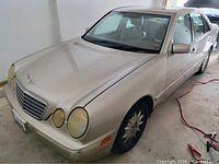 Passenger-side three-quarter view of entire vehicle in garage