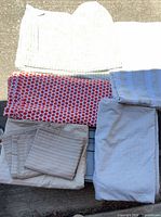 Group view of all folded bedding pieces showing patterns and colors