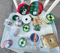 Top-down view showing full assortment of ribbon spools on plastic bin