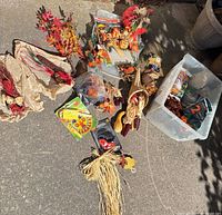 Entire lot spread on ground showing variety of autumn decorations and plastic bin