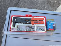 Open case showing rivet tool, compartments of rivets, spare nosepieces, and separate Mastercraft blister pack
