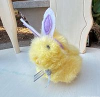 Front view of yellow plush chick with felt bunny ears and ribbon