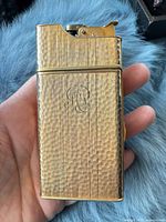 Front view showing textured exterior and monogram