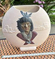 Front view showing relief portrait, landscape detail and ruler for scale