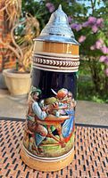 Full view of beer stein front showing tavern scene and pewter lid