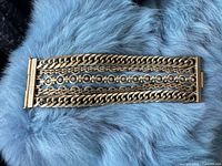Top view of bracelet displaying all chain strands and clasp