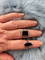 Both rings worn on hand showing stone shapes and sizes
