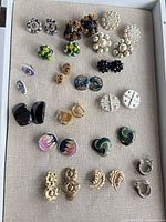 Full tray showing all 17 earring pairs arranged in rows