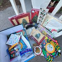 Lot overview showing Christmas napkins, New Year horns, banner, streamer, round clock decoration