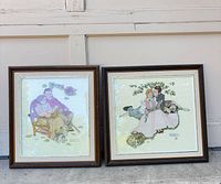 Both framed needlepoints side by side for scale and condition