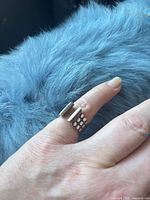 Ring worn on finger showing geometric ends