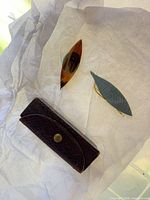 Shuttles and leather case on tissue