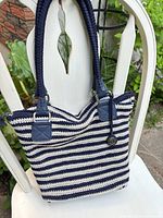 Front view of navy and white striped crocheted tote with dual handles