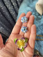 Front view of brooch and earrings showing enamel colours and design