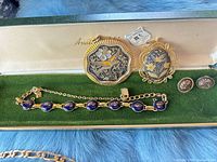 All jewelry pieces inside green case