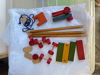 All pieces of the wooden construction set laid out on white background