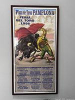 Full view of framed 1996 Pamplona bullfighting travel poster in wood frame
