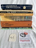 Stack of eight book spines showing titles and authors