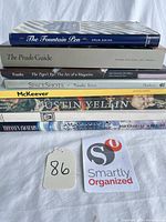 Stack of eight coffee table books showing spines