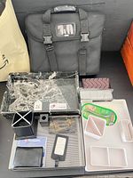 Overall lot showing laptop bag, trays, organizers, tape dispenser, pouches, accessories