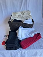 Stacked linens and basket showing colors and types