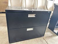 Front view of black two-drawer lateral file cabinet