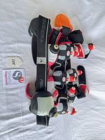 Belt-vest laid out with seven bottles visible, Design/Pro branding on strap