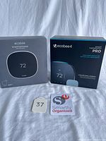 Front view of both boxed thermostats