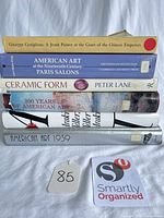 Stack of six hardcover books showing spines