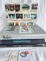 Stack of four hardcover books showing titles and spines