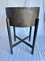 Side view of wood planter on black metal stand