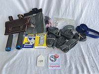 Group shot of all tubes, grips, pouches, strap, scale