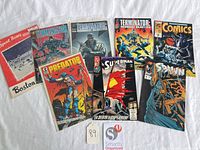 Group shot of all nine comics and program spread on white background