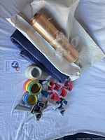 Overview of tape rolls, dispensers, moving blanket, kraft paper roll