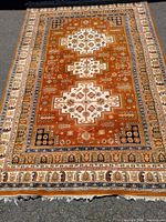 Full view of rust, beige and navy Oriental area rug
