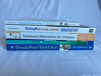 Stack of five paperback books showing titles and authors