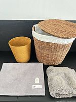 Large seagrass basket with lid and liner, yellow wastebasket, gray chenille bath mat, gray plush towel-mat