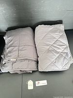 Both folded gray weighted blankets side by side