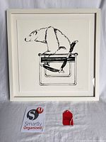 Front view of framed bear ink print with tags for scale