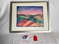 Front view of framed artwork showing image, mat, and frame