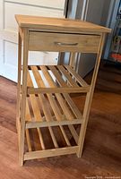 Full view of bamboo etagere showing drawer and slatted shelves