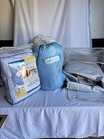 Sealed Therapedic pad, Aerobed bag, loose grey airbed displayed together