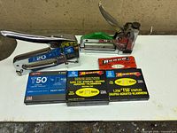 Overall lot showing two staplers and four staple boxes