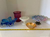 Group shot showing all five glass pieces with measuring tape for scale