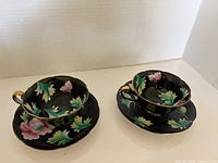 Both teacups on saucers showing overall design and color