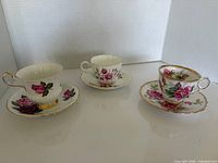 All three teacup and saucer pairs displayed side by side