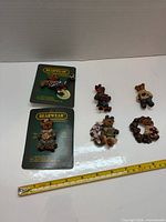 Overall lot showing two carded pins, four loose pins with scale
