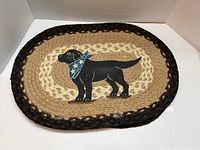 Oval braided jute placemat with black Labrador dog motif