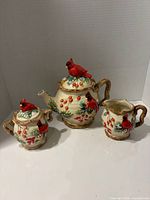 Front view of teapot, sugar bowl and creamer