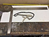 Framing square and chain locking pliers laid on bench